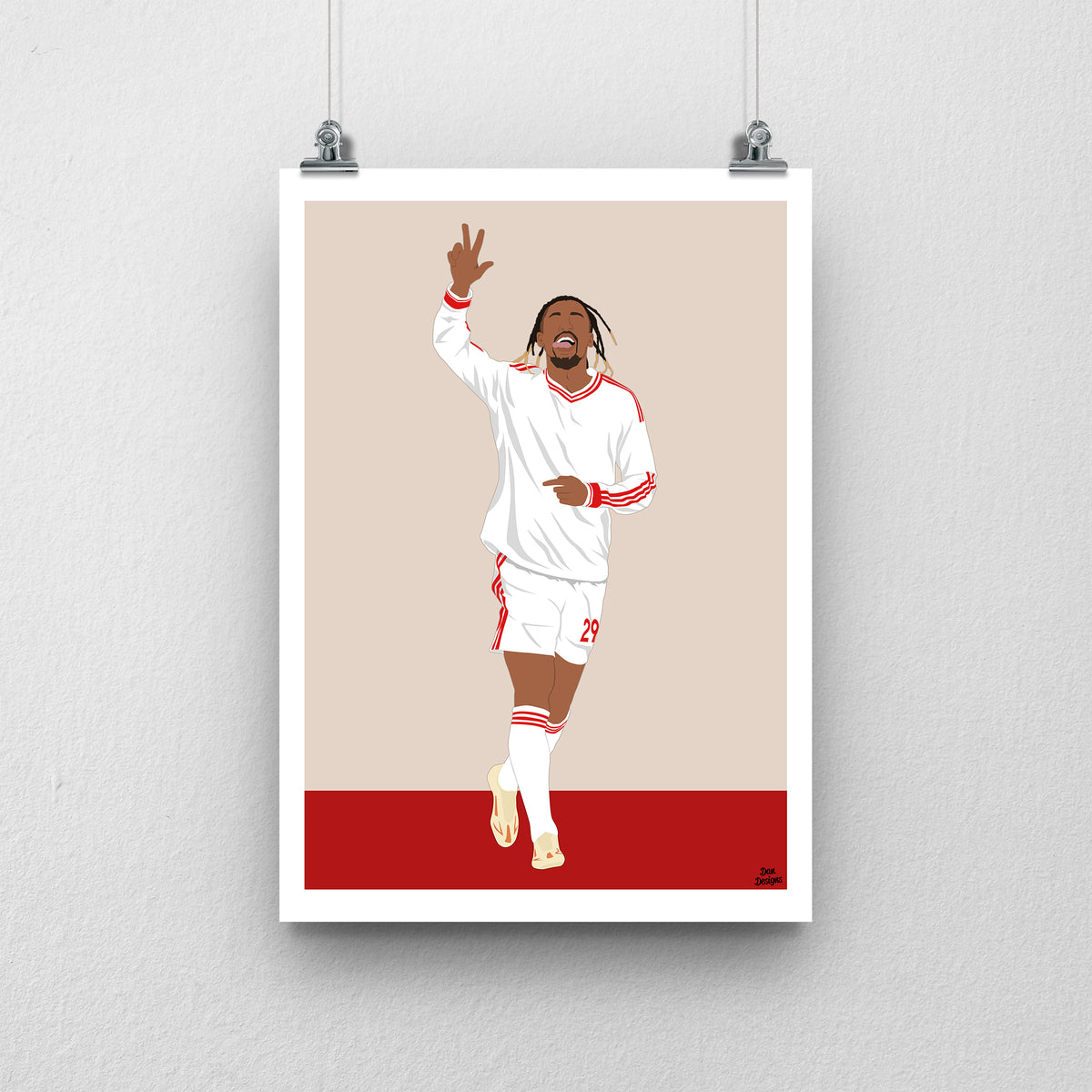 Bradley Barcola Liverpool print, celebrating with one hand raised in the white away kit, with a beige and red design and white border.