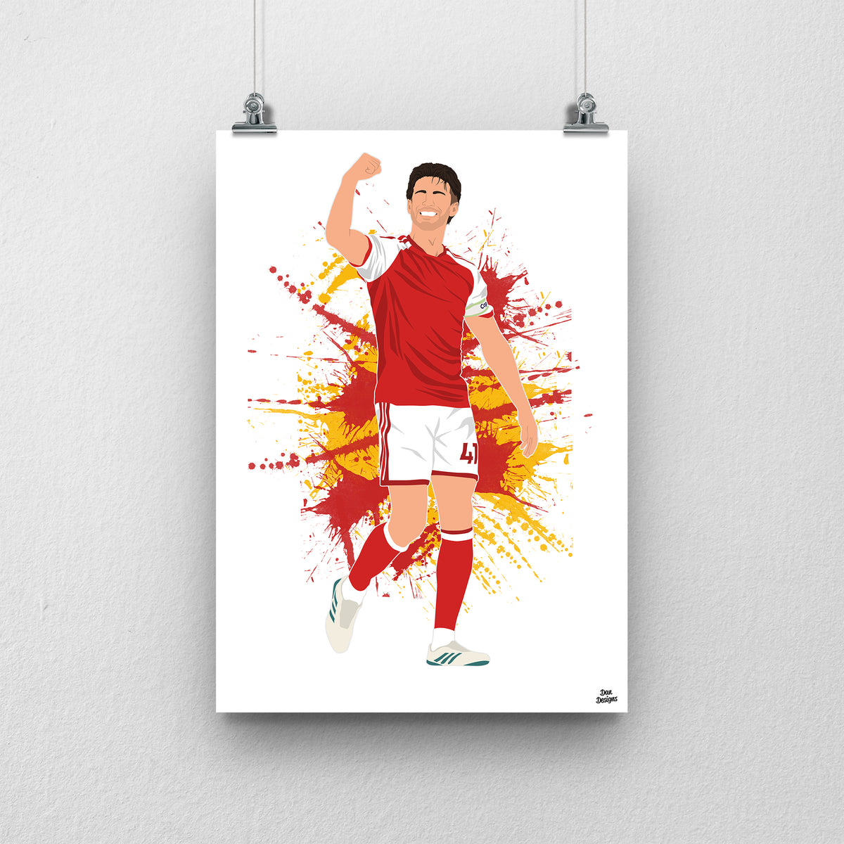 Declan Rice in Arsenal's red-and-white kit, celebrating with one arm raised and bent, against a red-and-gold paint-splatter background.