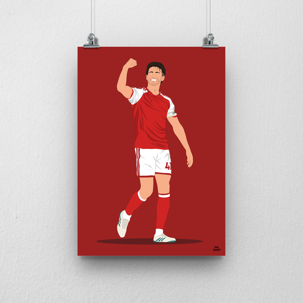 Declan Rice in Arsenal's red-and-white kit, celebrating with one arm raised and bent, against a red background.