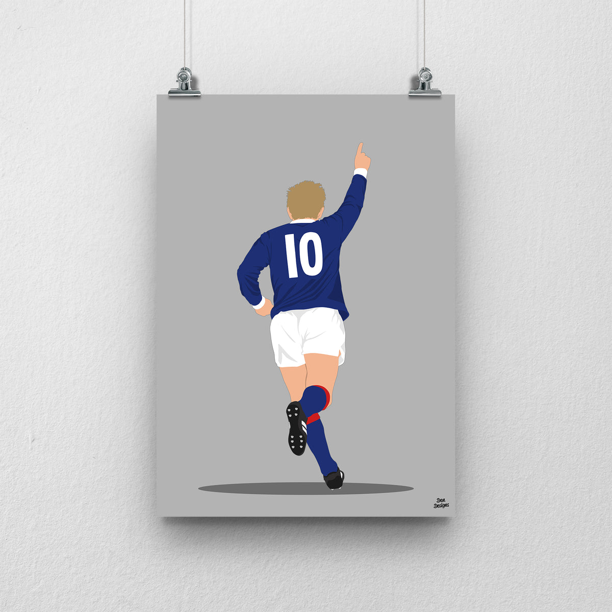 Denis Law running with one arm raised in Scotland’s navy number 10 shirt, illustrated with a grey background.