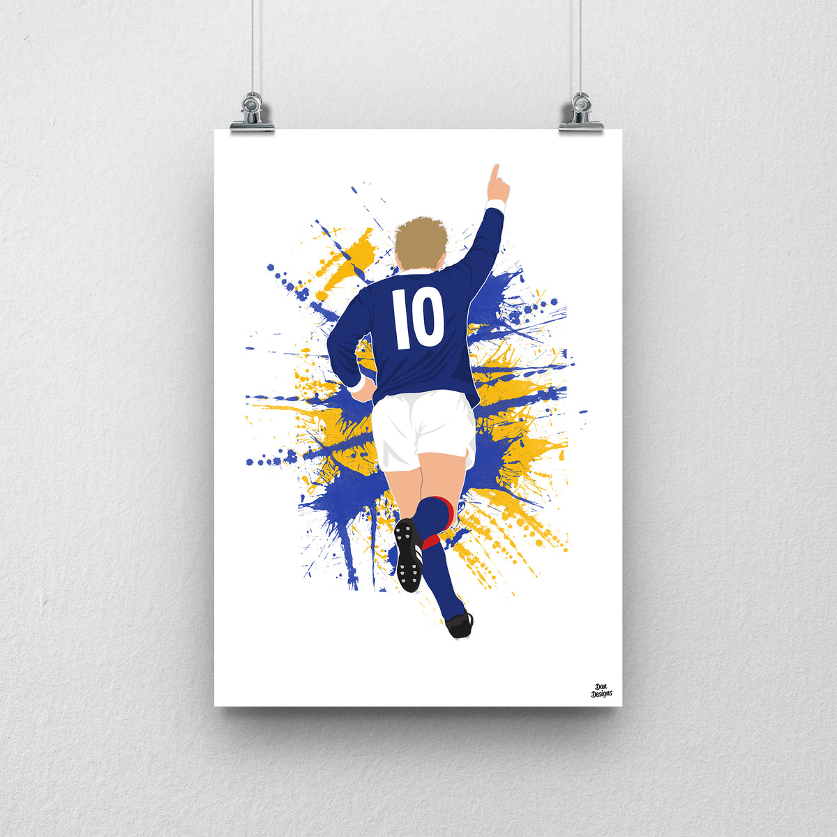 Denis Law running with one arm raised in Scotland’s navy number 10 shirt, illustrated with blue and yellow paint splashes on white.