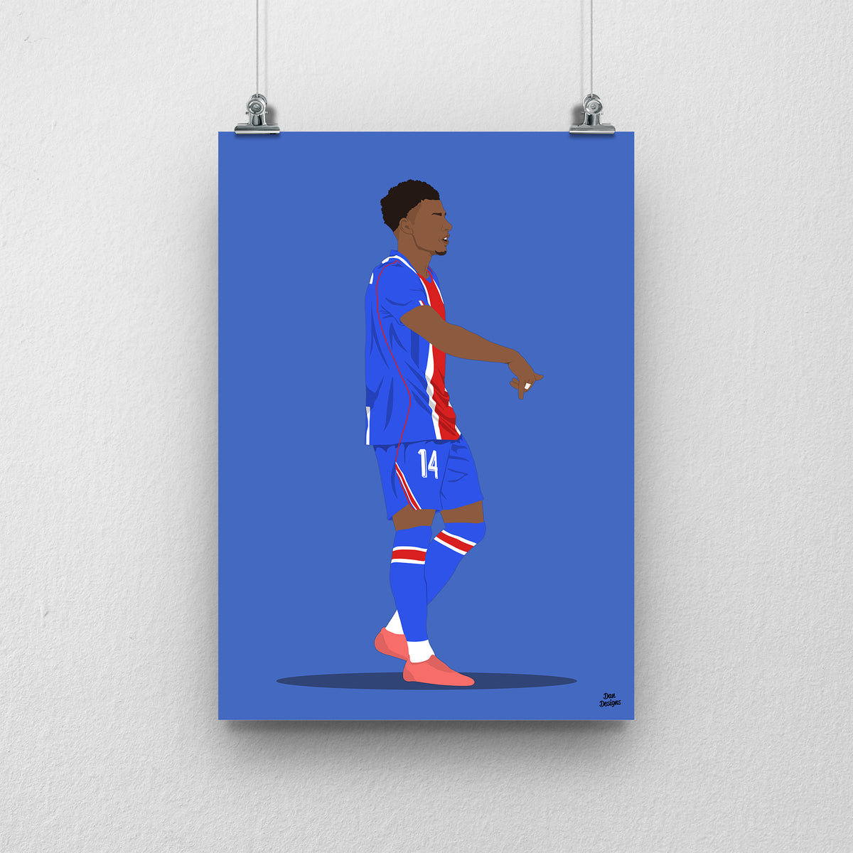 Désiré Doué in PSG's blue kit with a red central stripe, pointing downwards in celebration, against a blue background.