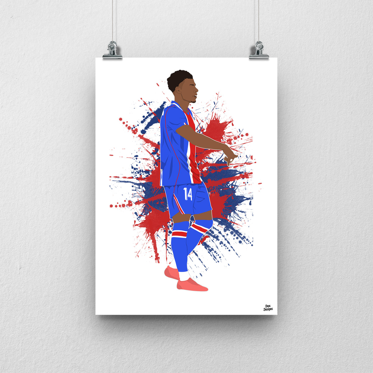 Désiré Doué in PSG's blue kit with a red central stripe, pointing downwards in celebration, against a red-and-blue paint-splatter background.