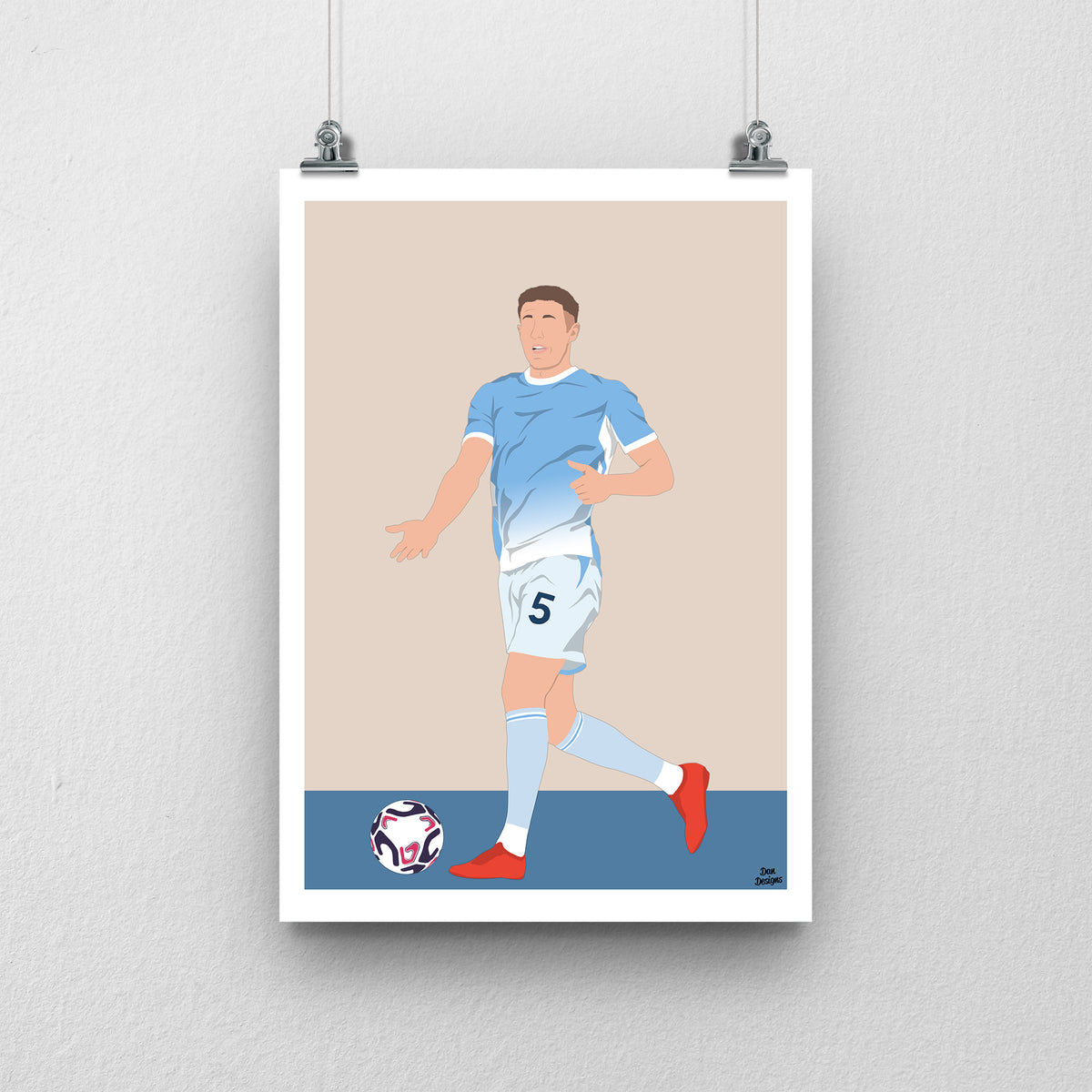 Elliot Anderson art print, with the ball at his feet in Manchester City's sky-blue shirt and number 5 white shorts, against a beige background with a white border and blue base.
