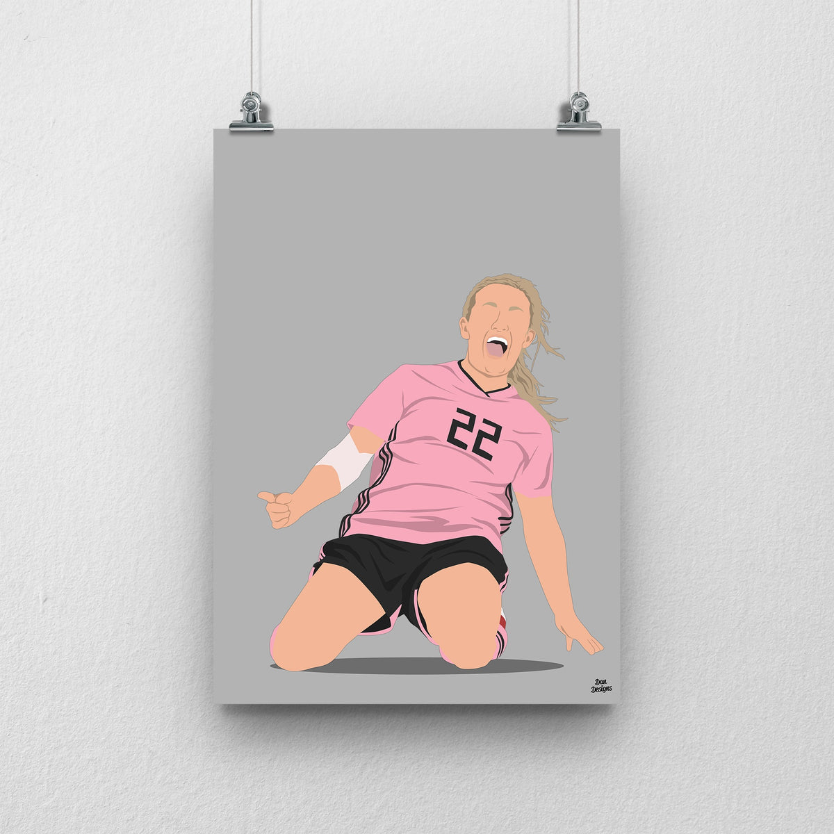 Erin Cuthbert sliding on her knees in Scotland’s pink number 22 shirt, illustrated with a grey background.