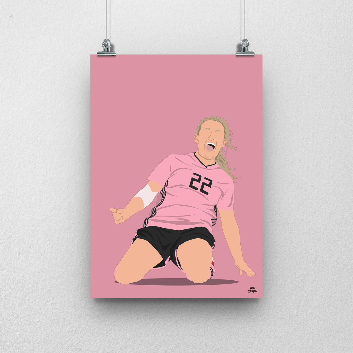 Erin Cuthbert sliding on her knees in Scotland’s pink number 22 shirt, illustrated with a pink background.