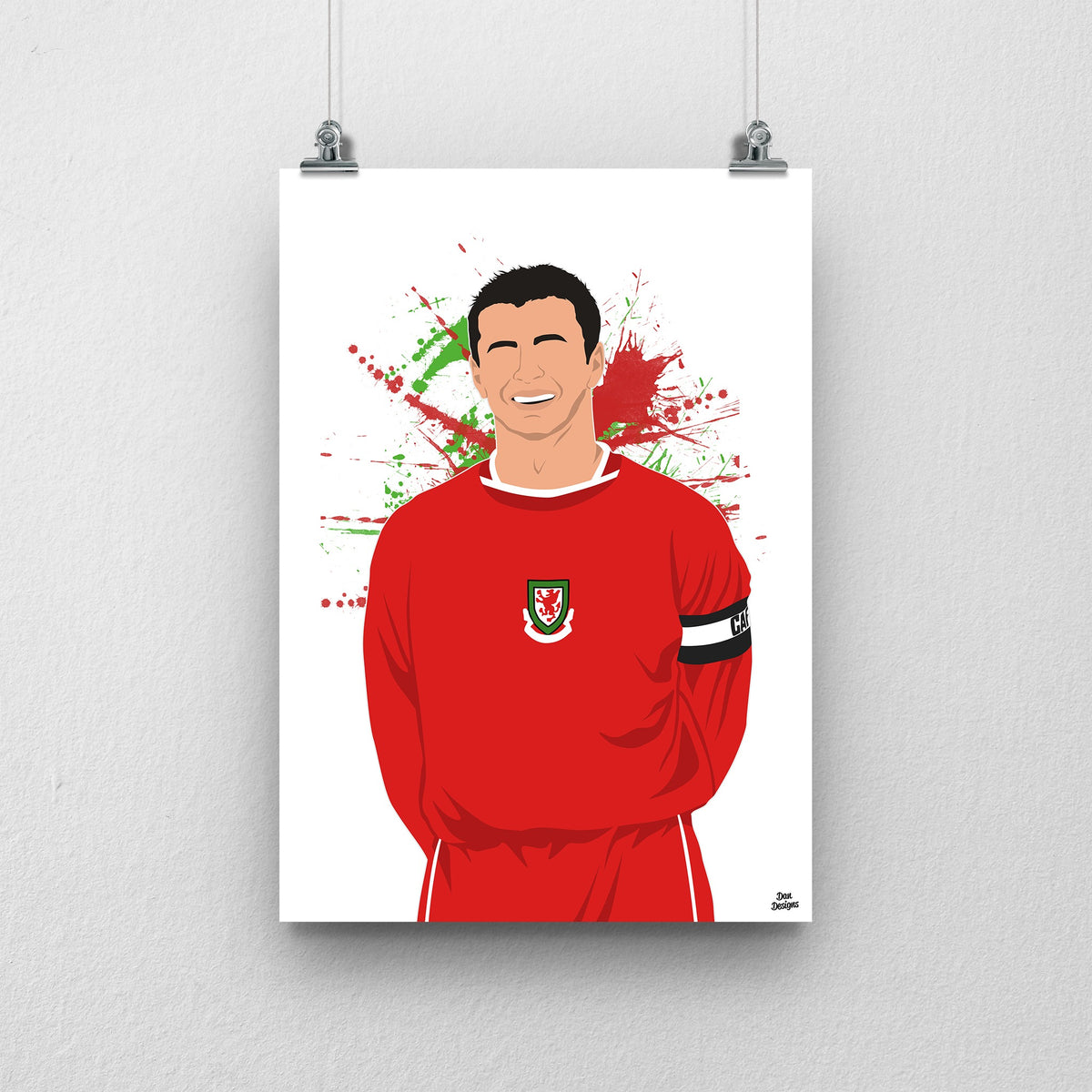 Gary Speed Wales print, smiling in the red Wales shirt with the captain’s armband, on a red and green paint-splatter background.