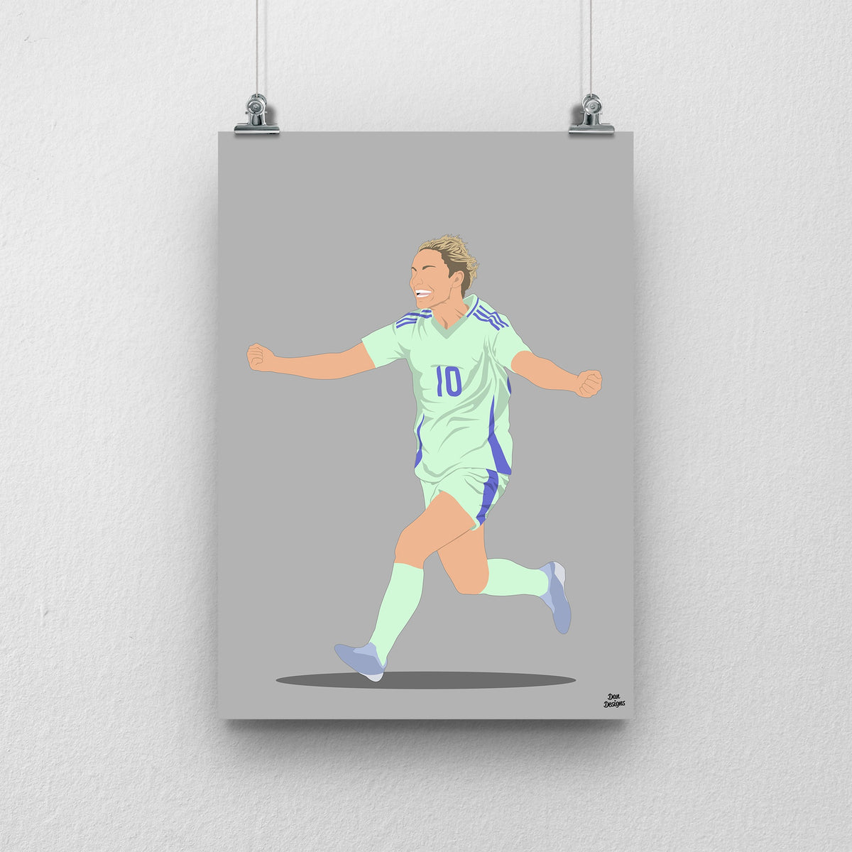Jess Fishlock Wales print showing her arms-out celebration in the green away kit, on a grey background.