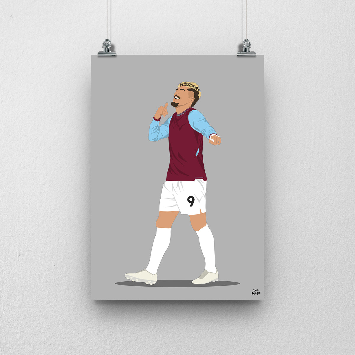 Joël Piroe in West Ham's claret shirt with sky-blue sleeves, holding a finger to his lips with his other arm extended, against a grey background.