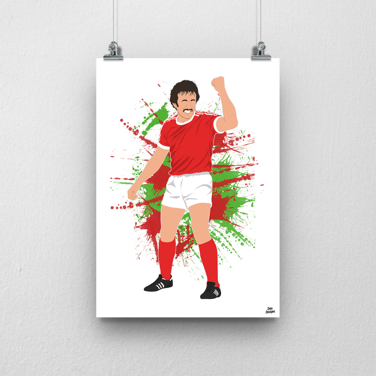 Joey Jones Wrexham print, raising his fist in the red Wrexham shirt, on a red and green paint-splatter background.