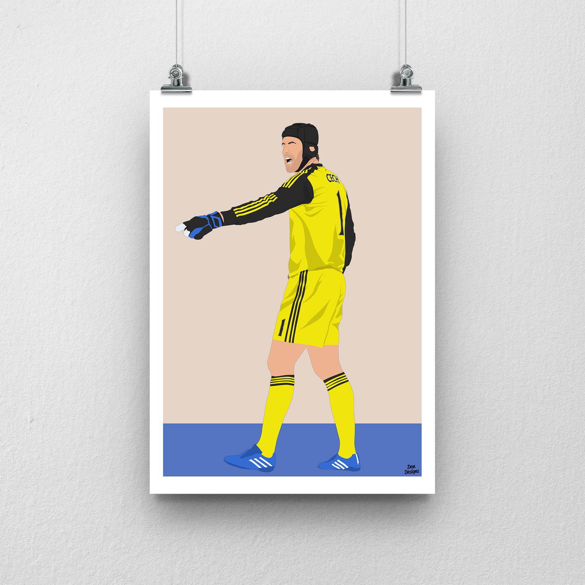 Petr Čech Chelsea art print, pointing across the pitch in a yellow goalkeeper kit, gloves and black protective headgear, with a beige background, white border and club-colour base.