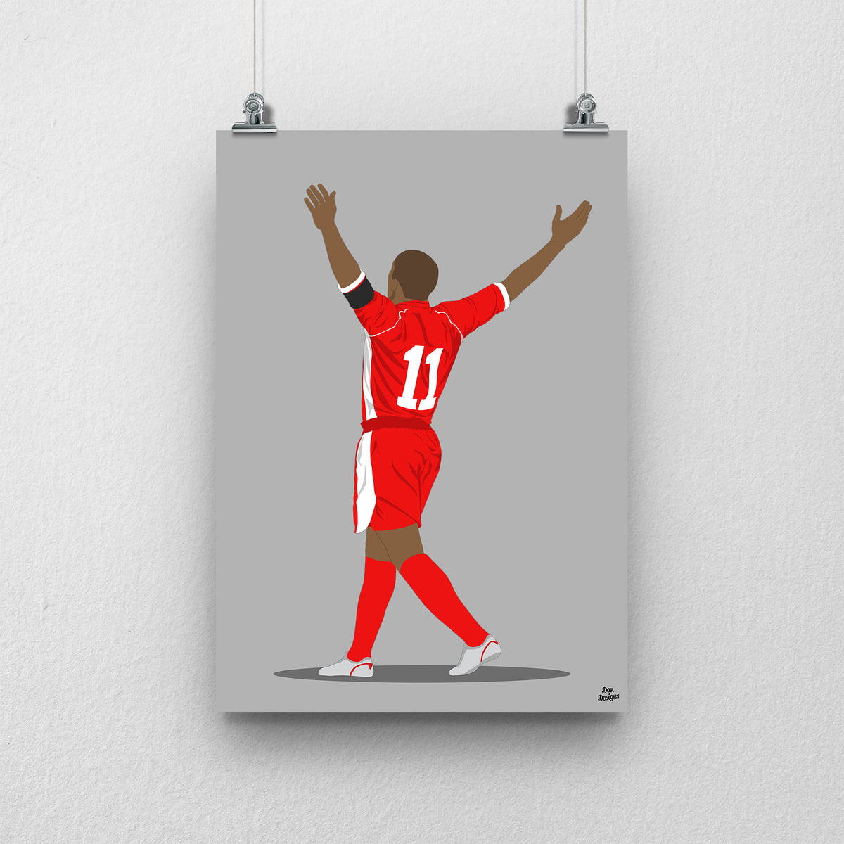 Robert Earnshaw Wales print, celebrating with both arms raised, viewed from behind, on a grey background.