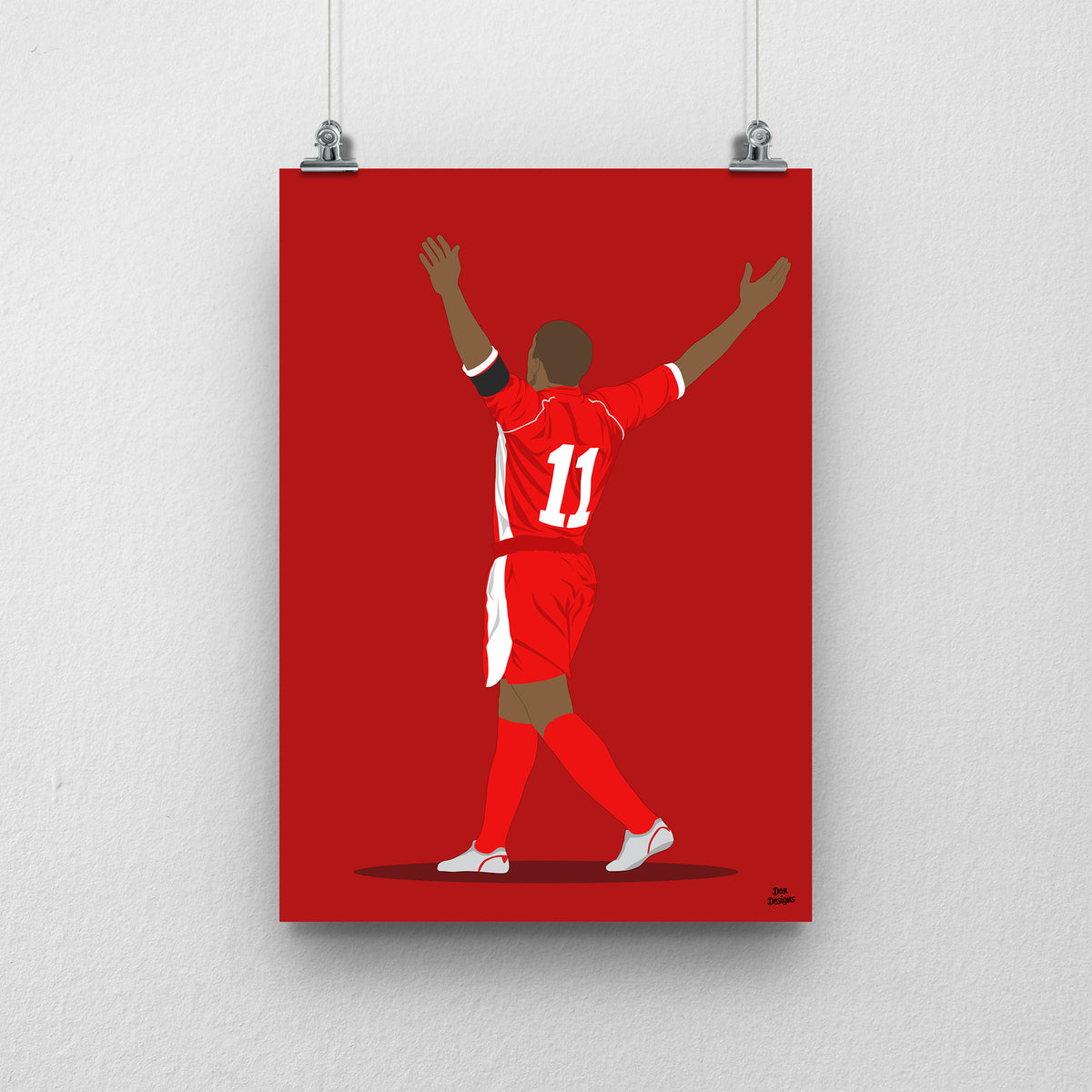 Robert Earnshaw Wales print, celebrating with both arms raised, viewed from behind, on a red background.