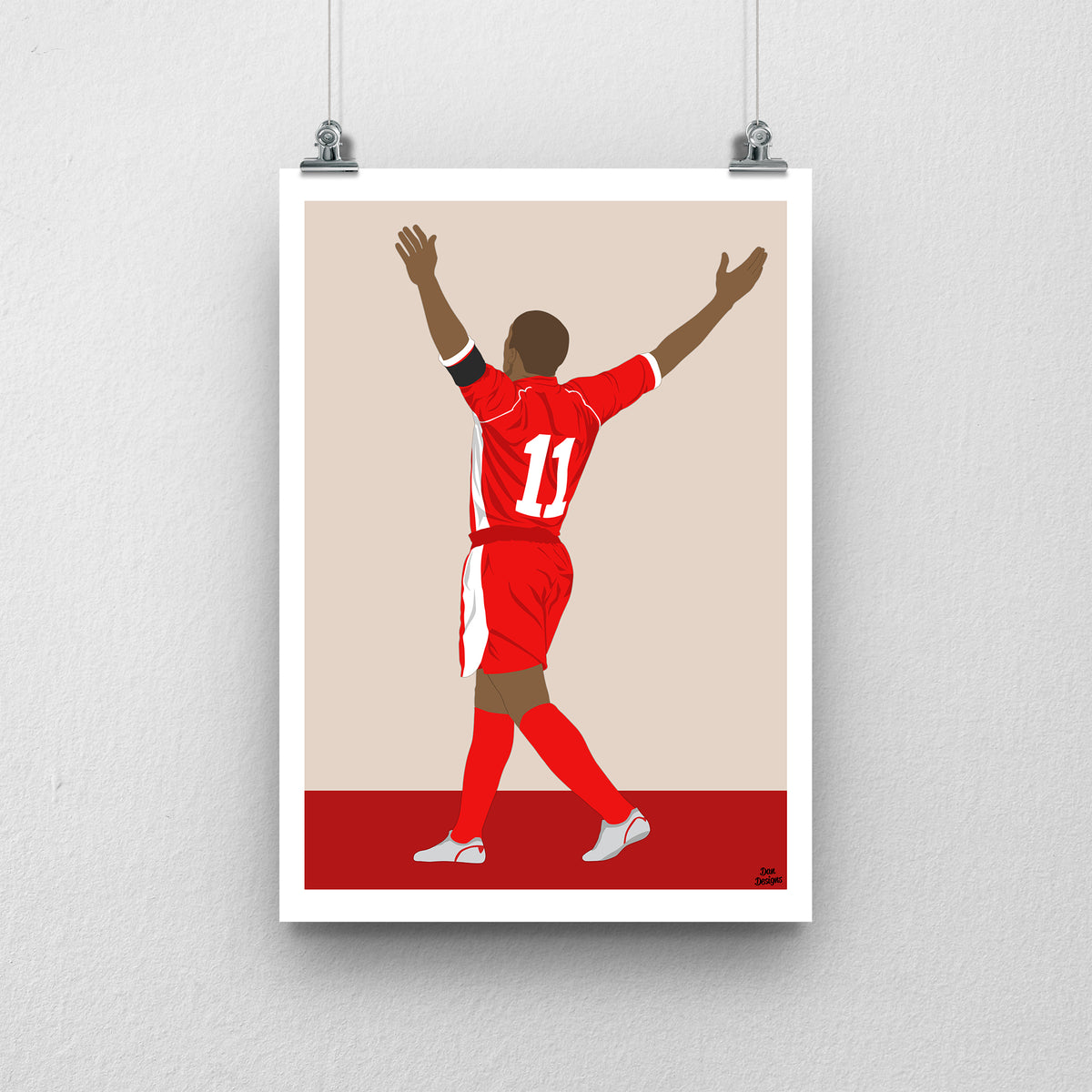 Robert Earnshaw Wales print, celebrating with both arms raised, viewed from behind, with a beige and red background and white border.