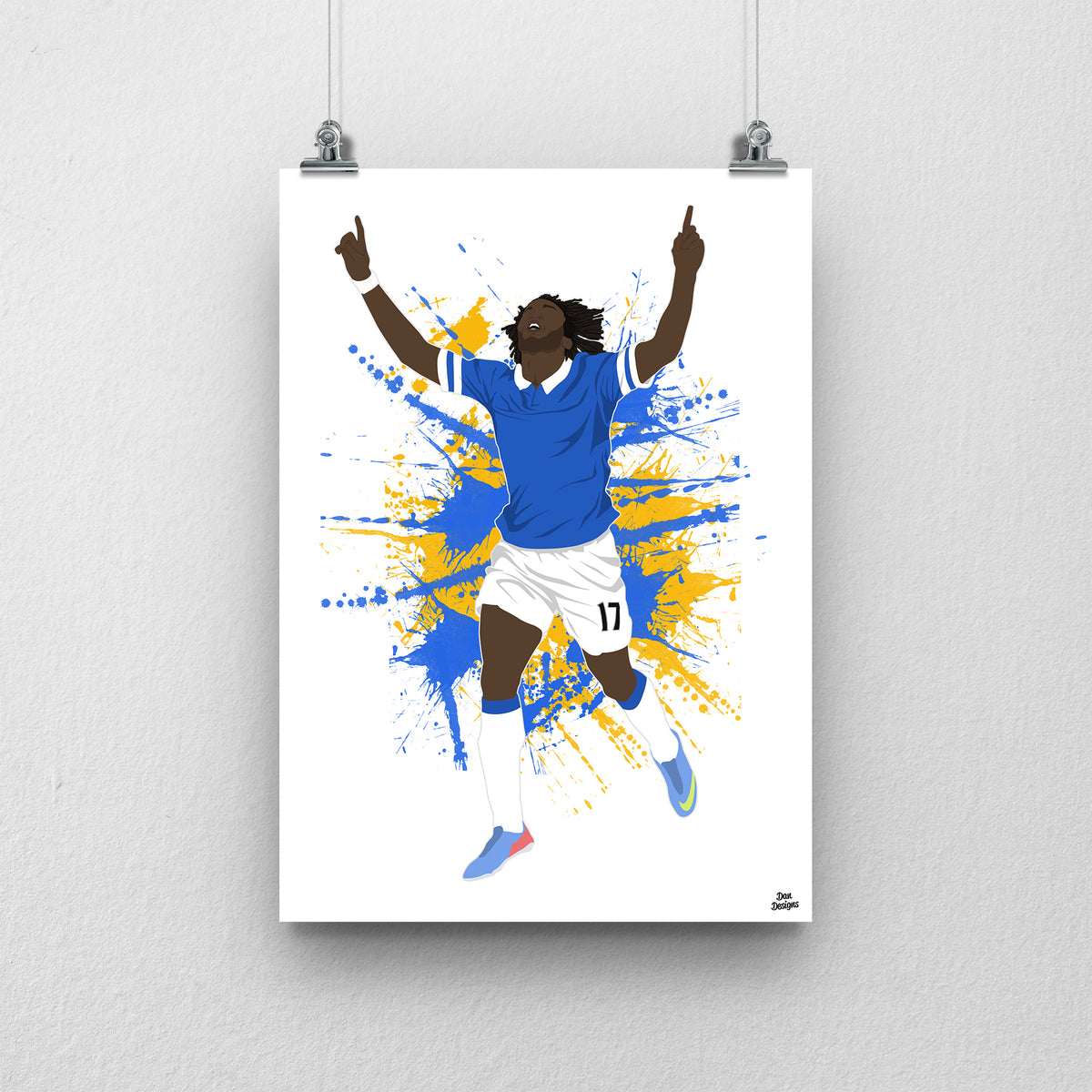 Romelu Lukaku Everton print, celebrating with both index fingers pointing upwards in the blue Everton kit, on a blue and yellow paint-splatter background.
