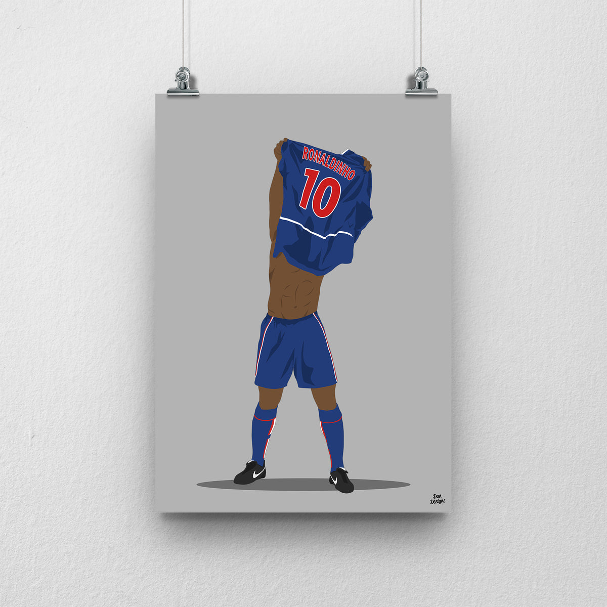 Ronaldinho art print, lifting his PSG shirt over his head with Ronaldinho and number 10 visible on the back, against a grey background.