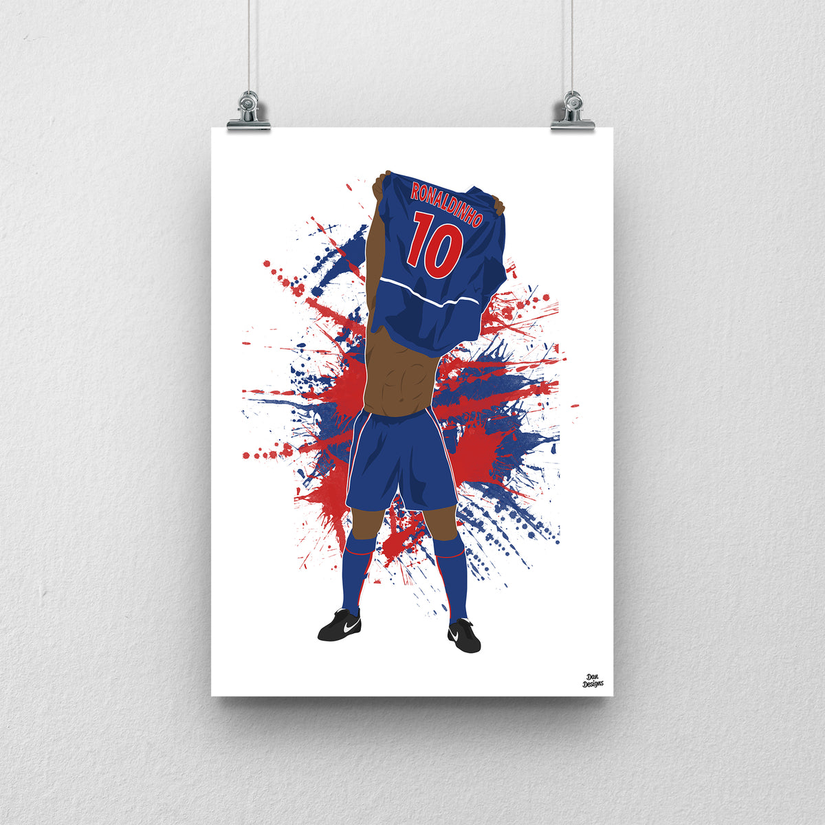 Ronaldinho art print, lifting his PSG shirt over his head with Ronaldinho and number 10 visible on the back, against a red-and-blue paint-splatter background.