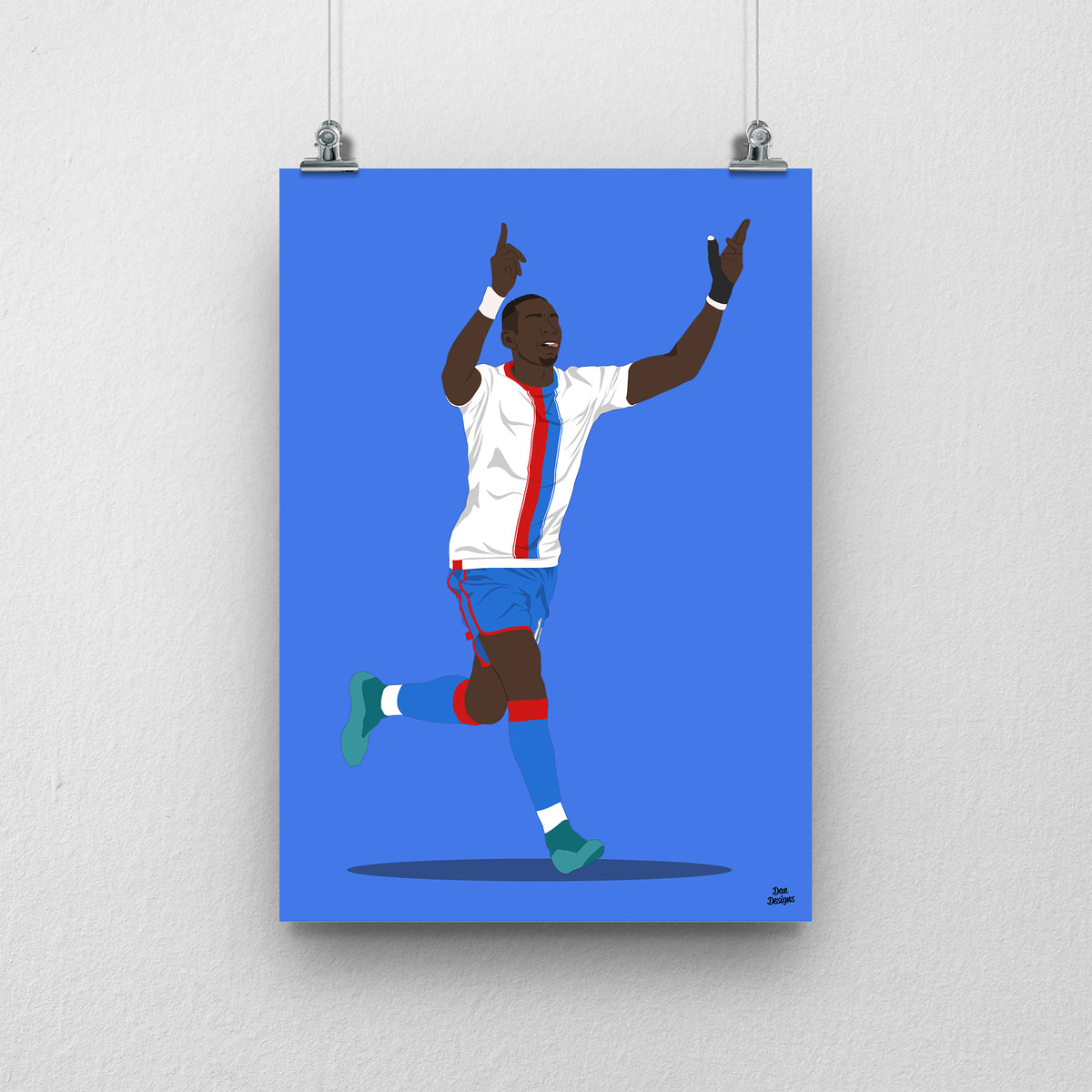 Yannick Bolasie Crystal Palace art print, celebrating with both hands pointing upwards in a white shirt with red-and-blue stripes, against a blue background.